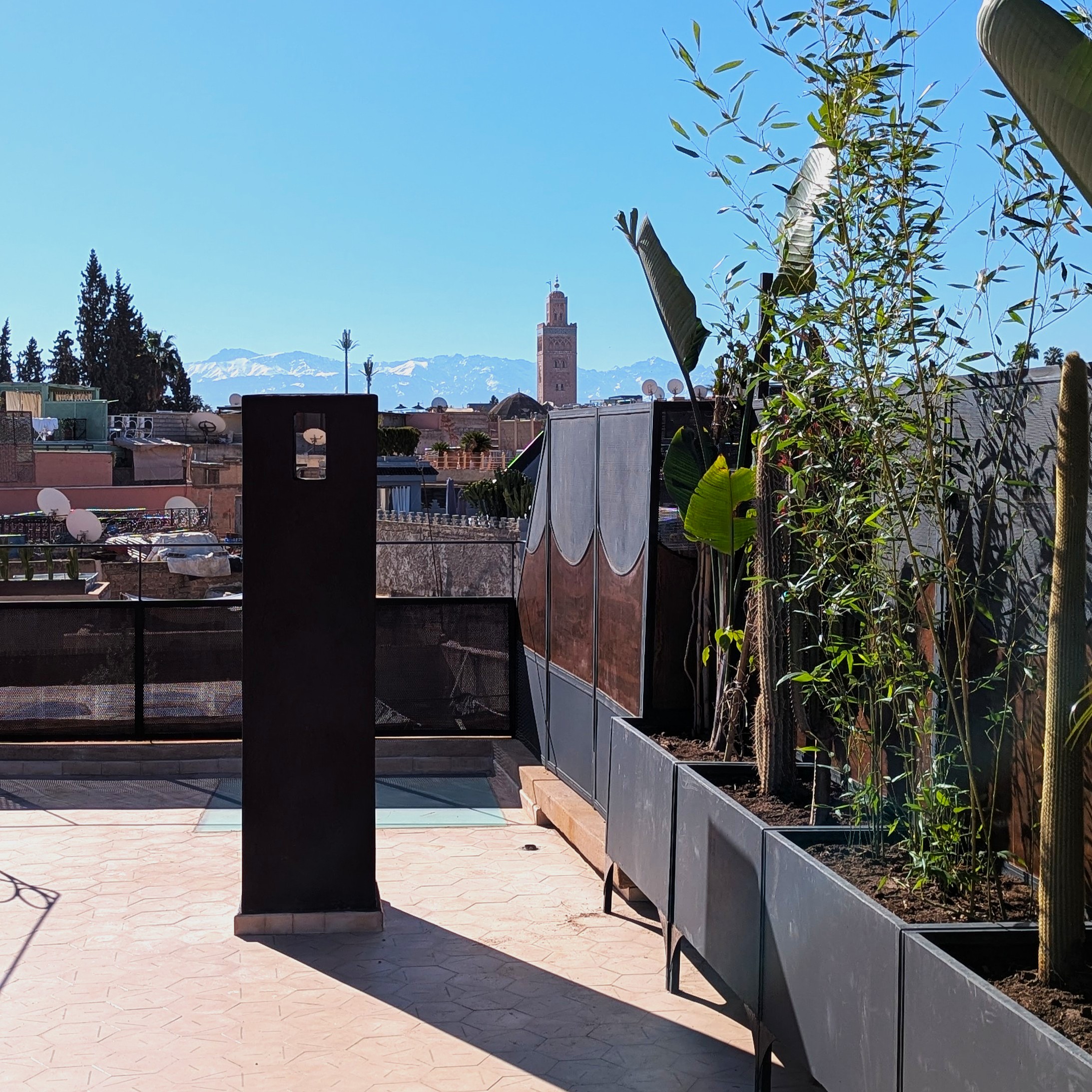 Palais Ambil rooftop — Koutoubia and Atlas Mountains view